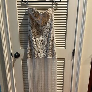 Sleeveless, lace gown with tassels